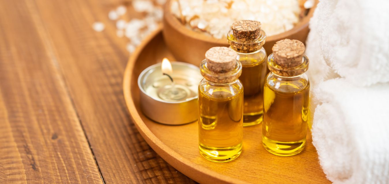 Öle, Kerzen, Salz und Handtücher auf einem Teller
