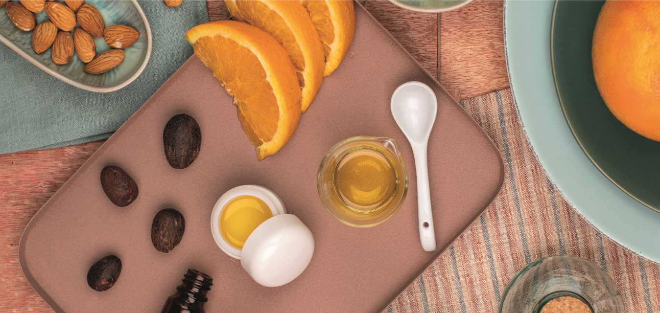 Natürliche Zutaten für Lippenpflege mit Orangen, Ölen und Nüssen